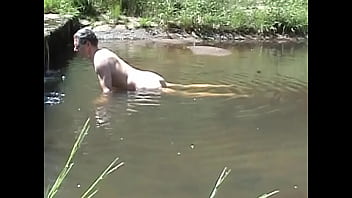 Cumming On A Stone In A River
