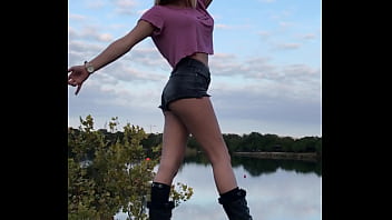 Gorgeous Blonde Model With Tiny Shorts With Perfect Ass Posing For Pictures On A Rock Overlooking The Lake