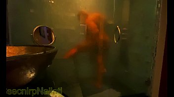 Ssecnirpnailati In A Fancy Shower Made Of Glass And Marble.