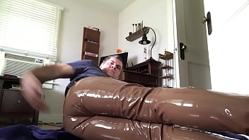 Man Masturbating In His Brown Leather Pants And Plastic Underwear Filled With Lube
