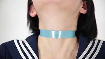 A Woman Drinking Water With A Ribbon Around Her Neck