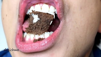 Eating Two Delicious Black Cupcakes