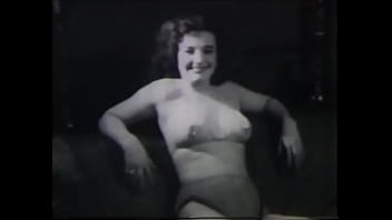 A Mature Lady With Dark Silky Hair Takes Part In The Filming Of A 60s Porn Film