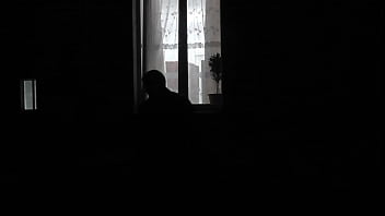 Peeping Through Windows. Voyeur. In Evening, On Street Random Passerby Guy Looking Into Bedroom Window And Filming On...