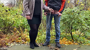 Hot Milf In Pantyhose And Skirt Holding Guy' Cock Outdoors While Pissing