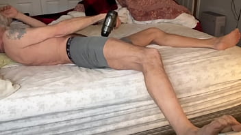 Stretching Tension In Bed With Massage Gun In On Bed In Tight Boxer Briefs July 2024