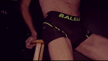 Grinding Up Close On Stool In Bicycle Shorts With Dark Background